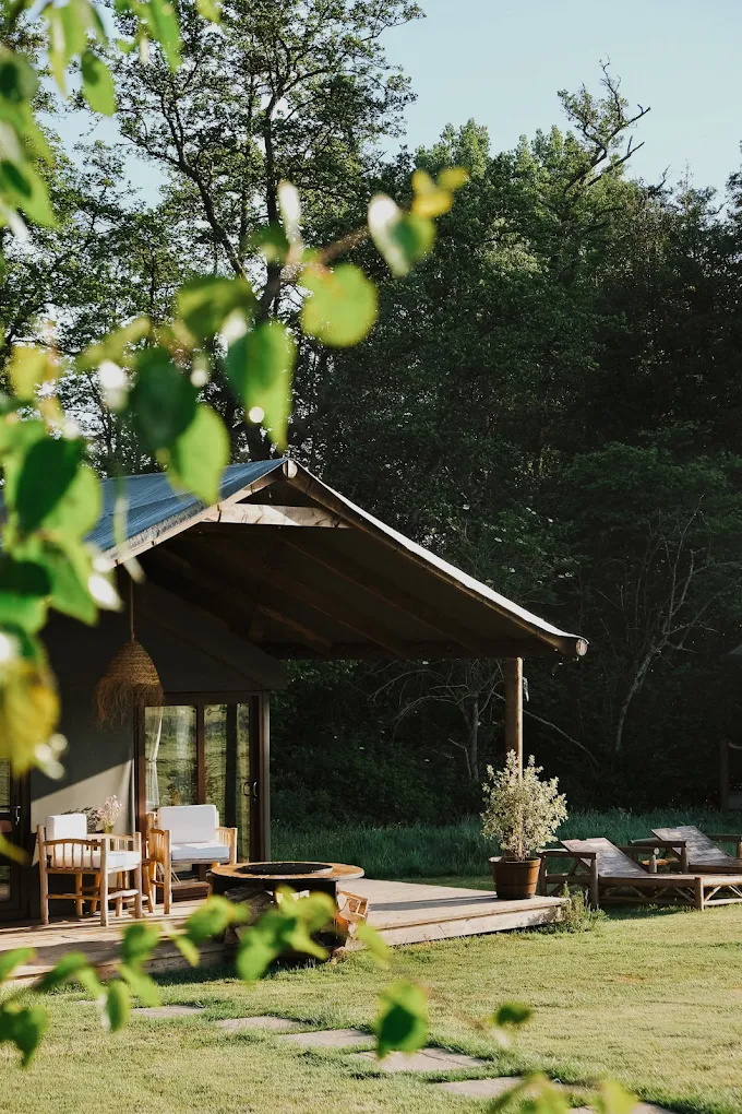 A Firesyde safari lodge surrounded by woodland and open sky